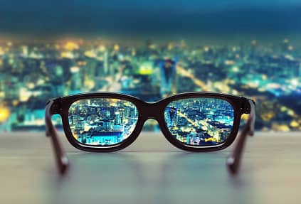 Night cityscape focused in glasses lenses. Vision concept, representing point of view
